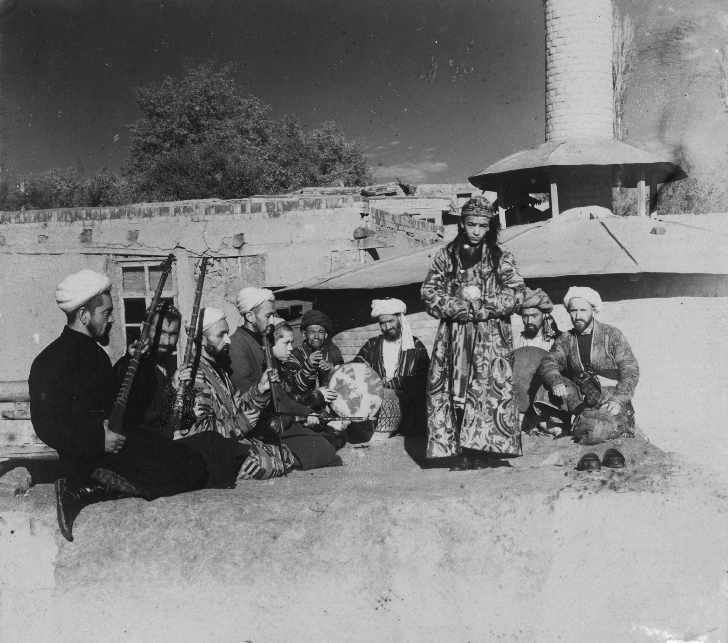 Samarkand A group of musicians playing for a bacha dancing boy